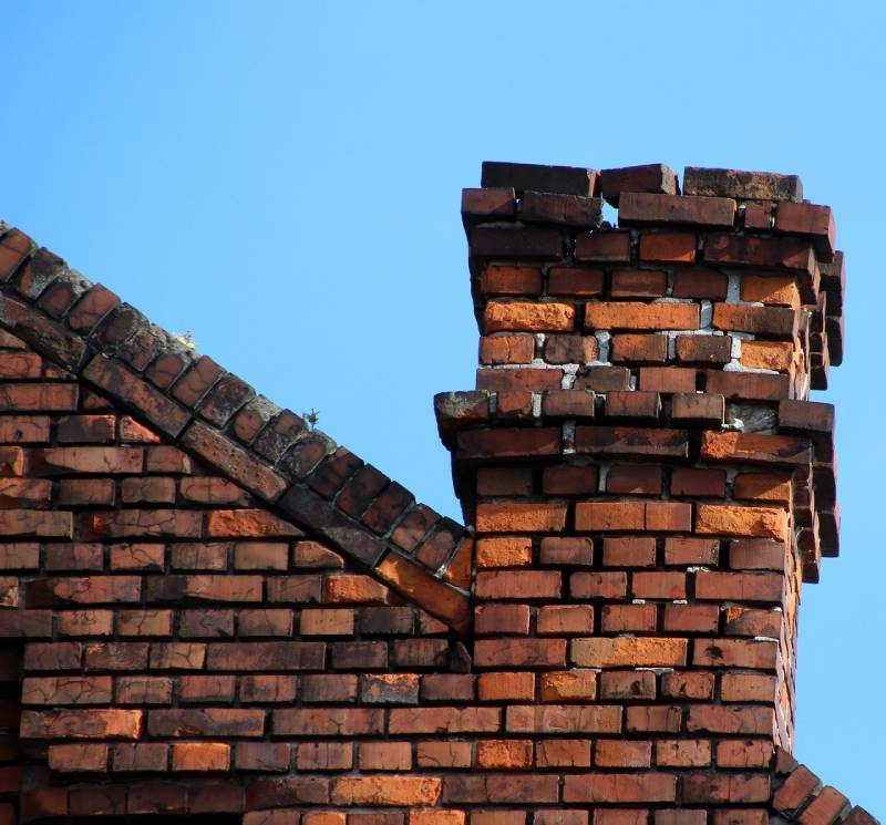 Signs Your Bensenville Home Needs a Chimney Inspection Damaged chimney on an Bensenville home showing cracks and missing mortar